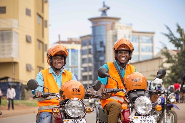 Two SafeBoda riders sitting on their bikes