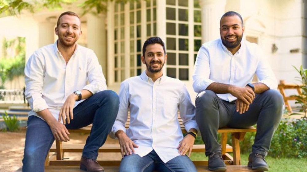 Three men sitting on a bench