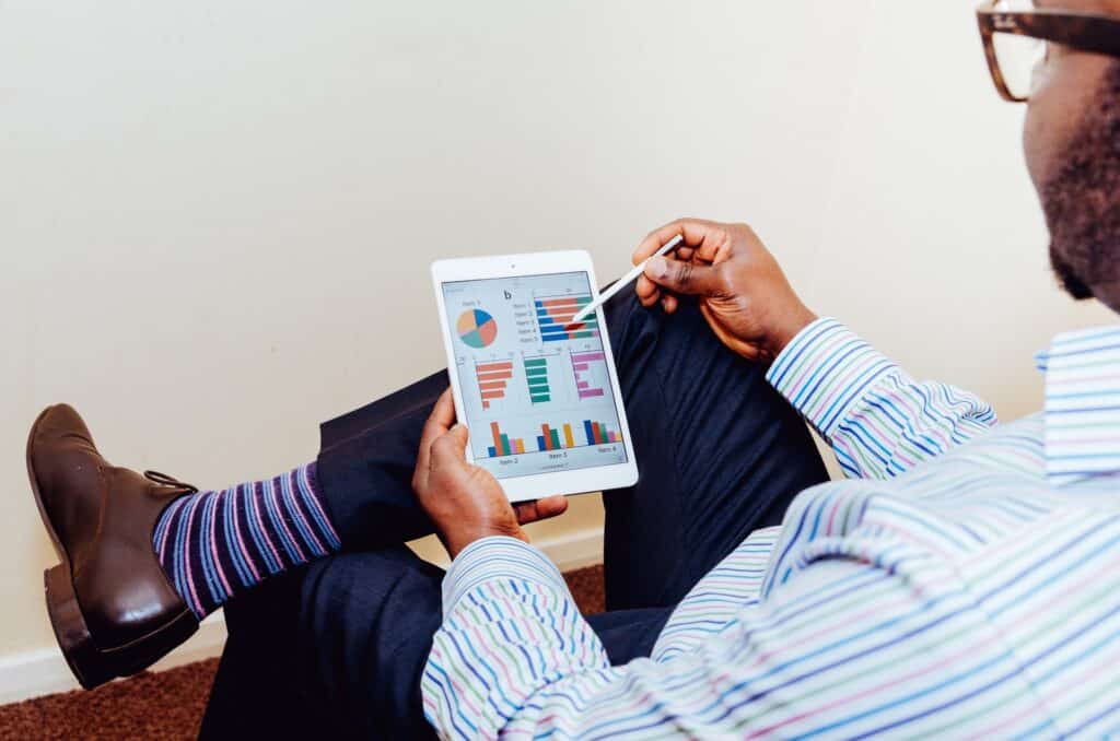 Man using ipad with data visualisations