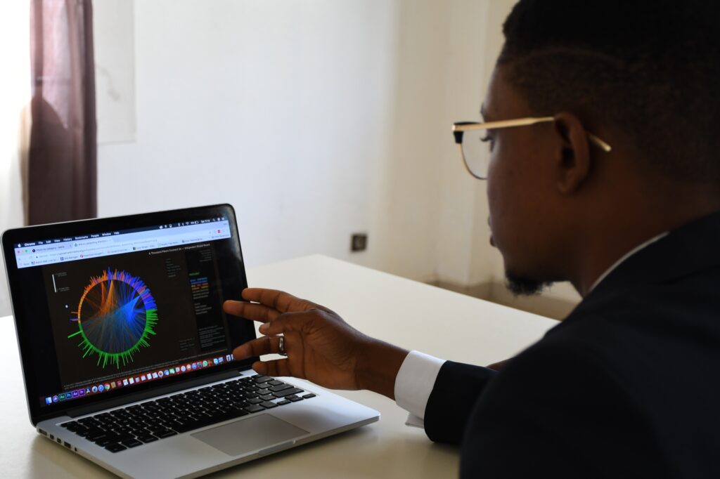 Man with laptop and visualisations on screen