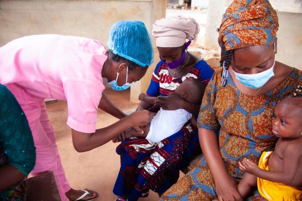 Photo of a nurse attending to nursing mothers at a healthcare facility via Iwaria