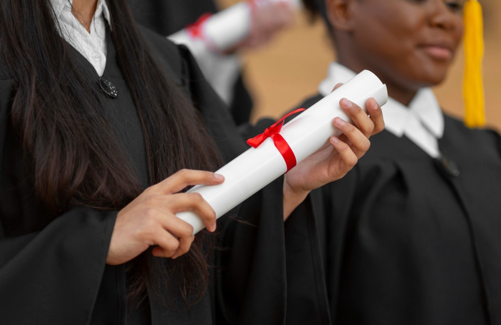 close up graduate students with gown