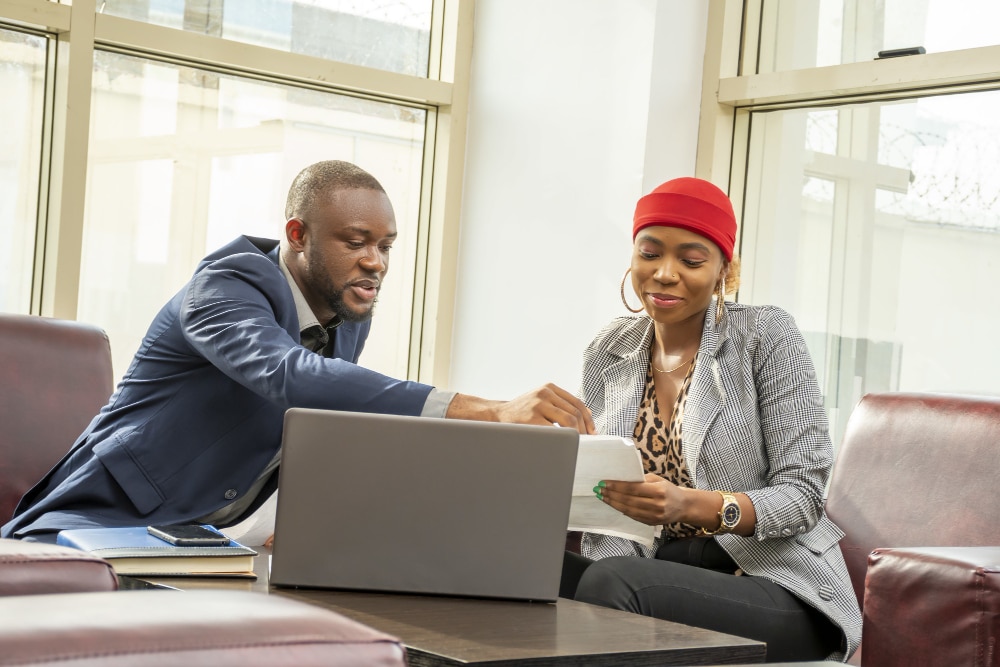 young black businessman woman going through some paperwork together