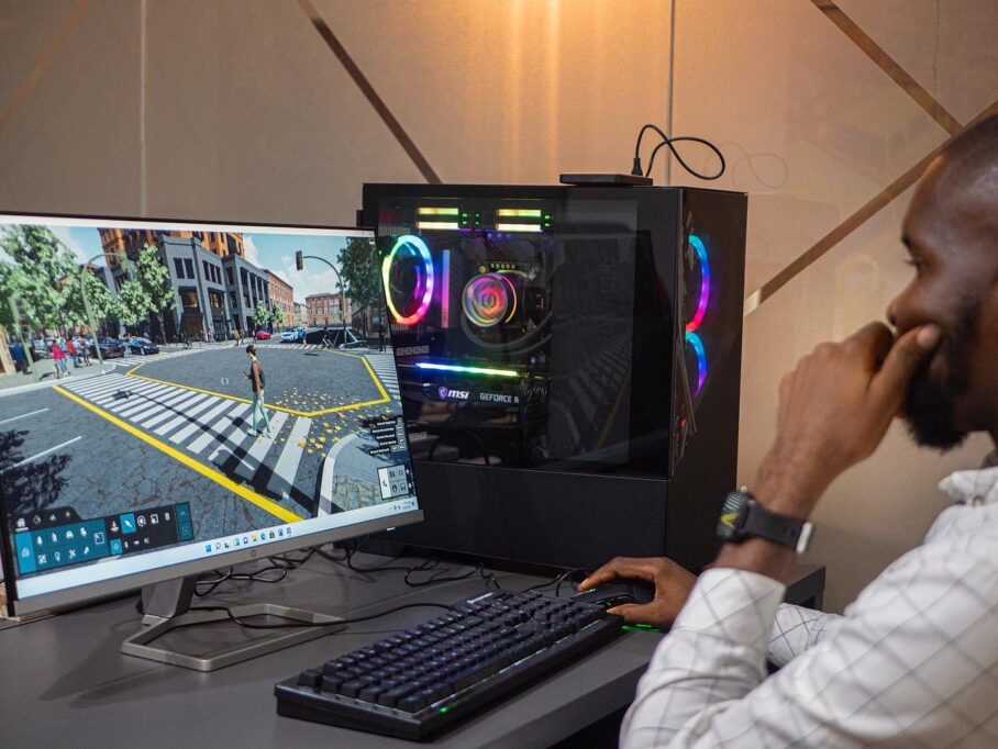 Someone using a monitor and PC setup with RGB lighting.