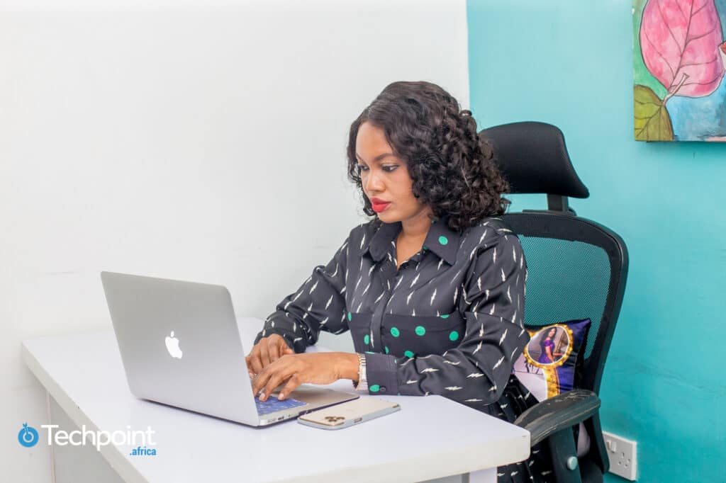 An image of Florence Chikezie, founder, ReDahlia/Entrepreneurs.ng is working on her laptop