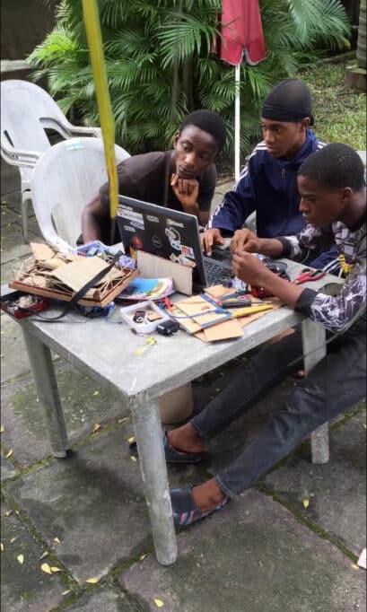 Three teenagers, staring at a laptop