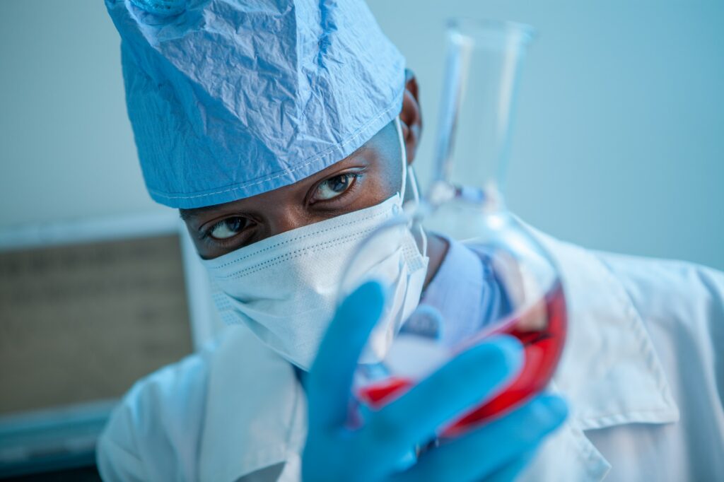 A researcher holding a cylinder in the lab