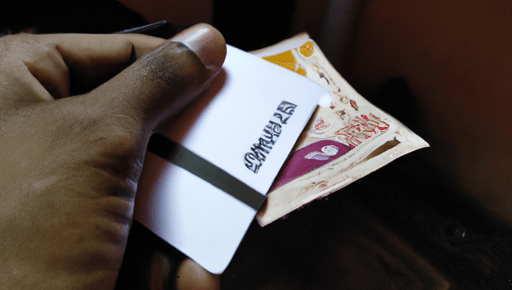 A picture of someone making payment-with-a-card-and-Rupees