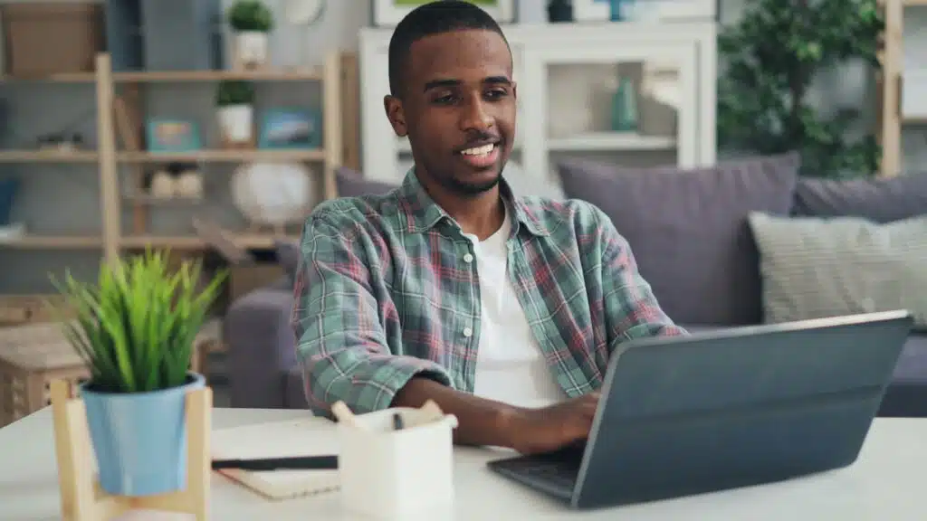 Black man looking at a laptop 